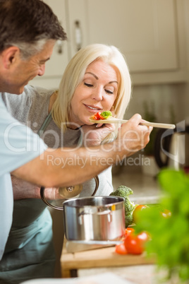 Mature couple preparing vegetarian meal together