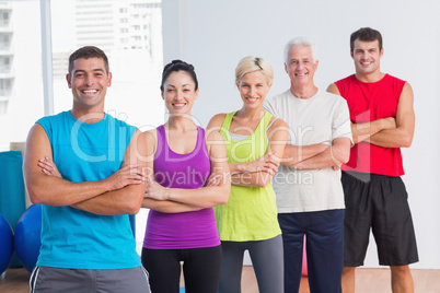 People standing arms crossed at fitness studio