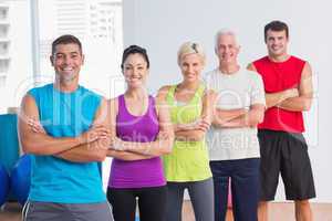 People standing arms crossed at fitness studio