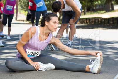 Fit woman warming up before race