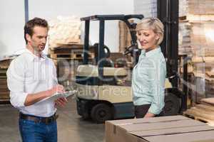 Two warehouse managers checking inventory