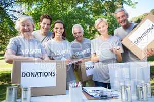 Happy volunteer family holding donation boxes