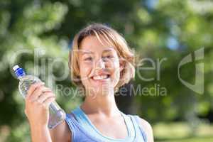 Fit blonde in the park with water bottle