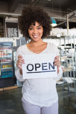 Pretty worker showing open sign