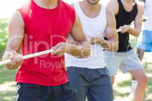 Fitness group playing tug of war