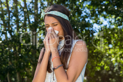 Pretty brunette blowing her nose