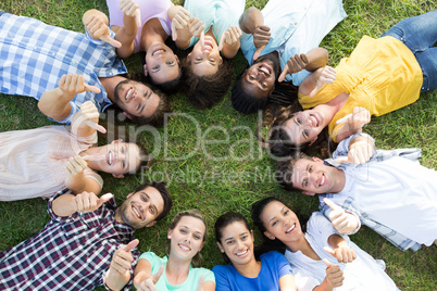Happy friends in the park lying in circle