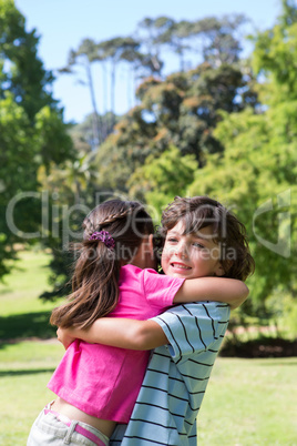 Little siblings hugging each other