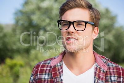 Handsome hipster thinking in the park