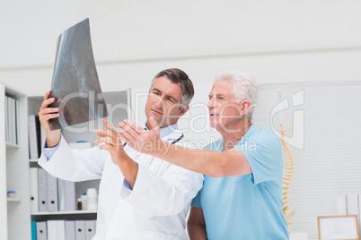 Doctor discussing with patient over x-ray