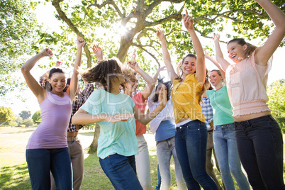 Happy friends in the park cheering