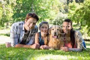 Happy family with their dog in the park