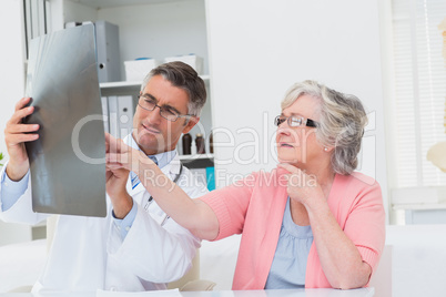 Doctor explaining x-ray to senior patient