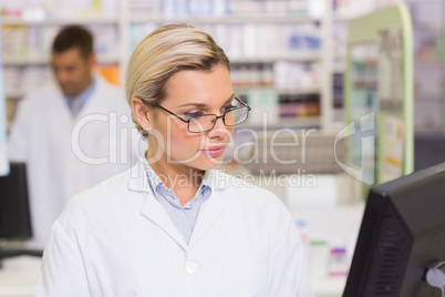 Concentrate pharmacist looking at computer