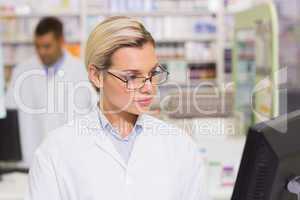 Concentrate pharmacist looking at computer
