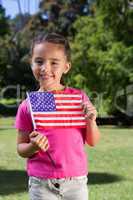 Little girl waving american flag