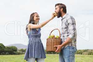 Couple holding basket full of apples