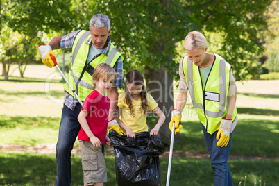 Happy family collecting rubbish