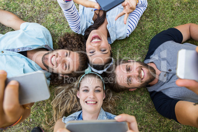 Happy friends lying on the grass