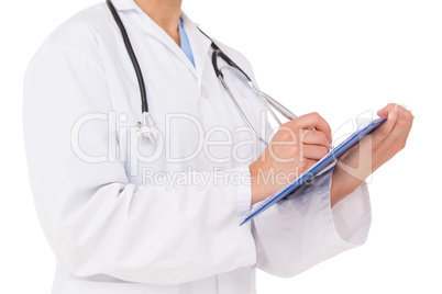 Doctor writing on clipboard