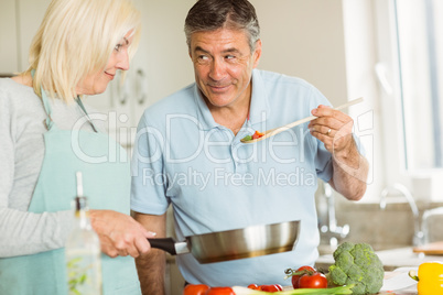 Happy mature couple making dinner together