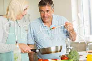 Happy mature couple making dinner together