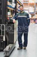 Manual worker leaning against the forklift