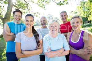 Happy athletic group with arms crossed