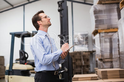 Warehouse manager checking his inventory