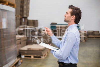 Warehouse manager checking his inventory