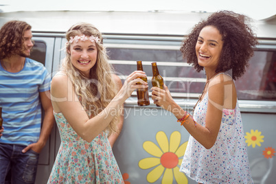 Pretty hipsters toasting with beer