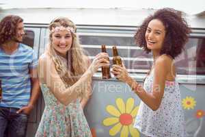 Pretty hipsters toasting with beer