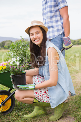 Happy young couple gardening together