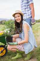 Happy young couple gardening together