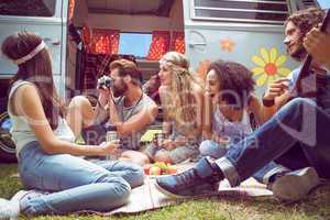 Hipster friends by camper van at festival