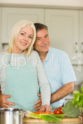 Happy mature couple making dinner together