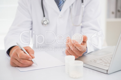 Vet writing on clipboard the prescriptions