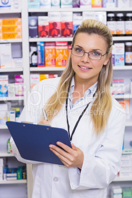 Pharmacist writing on clipboard