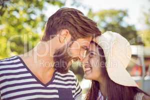 Hipster couple smiling at each other