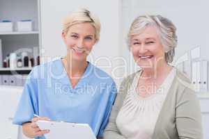 Nurse and patient smiling in clinic