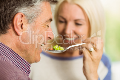 Mature couple preparing meal together