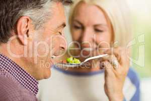 Mature couple preparing meal together