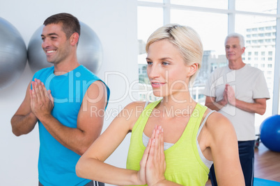 People meditating in fitness club