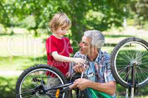 Father and his son fixing a bike