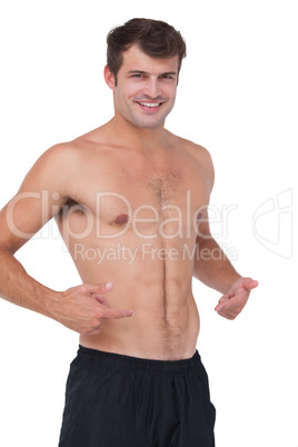 Fit shirtless man smiling at camera