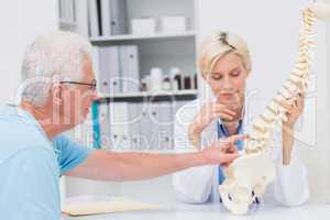 Patient showing spine problems to doctor