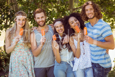 Hipster friends enjoying ice lollies