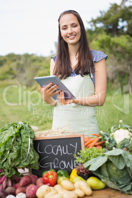 Woman selling organic vegetables at market