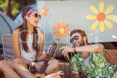 Happy hipsters relaxing on the campsite