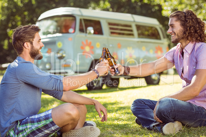 Hipster friends toasting with beers